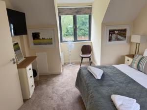 a bedroom with a bed and a desk and a window at Large four bedroom town centre house in Killarney