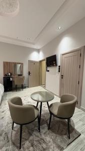 a living room with a table and two chairs at Qubaa Soul Studio 2-3 in Medina