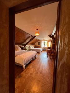 a bedroom with a bed and a large mirror at Le Clos Colette in Neuvy