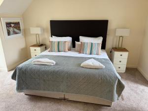 a bedroom with a large bed with two night stands at Large four bedroom town centre house in Killarney