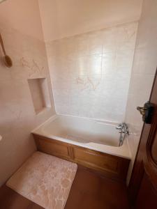 a bathroom with a bath tub in a room at Le Clos Colette in Neuvy +28 photos