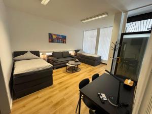 a living room with a couch and a table at City Apartment in Siegen