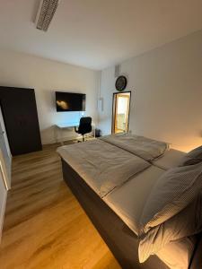 a bedroom with a bed and a clock on the wall at City Apartment in Siegen