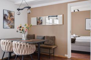 a dining room with a table and chairs and a bedroom at The Brown Door in Stavanger