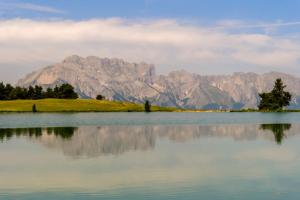 a view of a mountain range from a lake at La VilLaye in Laye +8 photos