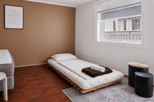 a bed in a room with a window at The Brown Door in Stavanger +11 photos