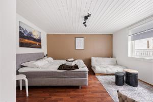 a living room with a bed and a couch at The Brown Door in Stavanger