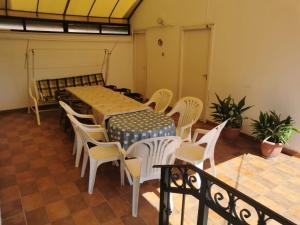 a dining room with a table and chairs at Kossuth Apartman in Hajdúszoboszló