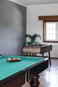 a billiard table in a room with a pool table at Casa da presa in Ponte de Lima