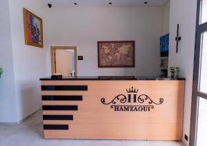 Ein Empfangstresen mit einem Schild, auf dem Hawaiitown steht in der Unterkunft Hotel Hamzaoui in Beni Mellal