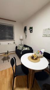 a living room with a table and a couch at The Nook Apartment in Jesenice