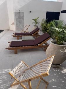 a patio with two lounge chairs and a table at Keur Noflaye Ngaparou in Mbour