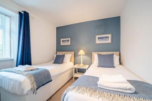 two beds sitting next to each other in a bedroom at 2 Bed in Portpatrick oc-p43756 in Portpatrick