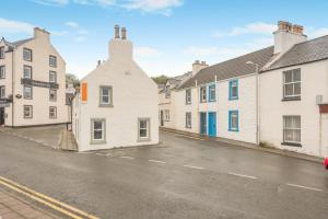 a row of white houses on a street at 2 Bed in Portpatrick oc-p43756 in Portpatrick