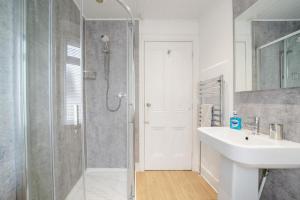 a white bathroom with a sink and a shower at 2 Bed in Portpatrick oc-p43756 in Portpatrick +18 photos