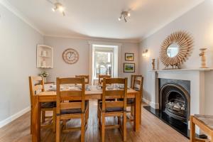 a dining room with a table and chairs and a fireplace at 4 Bed in Portpatrick oc-p43755 in Portpatrick