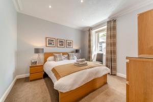 a bedroom with a large bed and a window at 4 Bed in Portpatrick oc-p43755 in Portpatrick