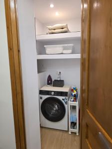a washer and dryer in a small room at LUM Luxury Studios in Rethymno