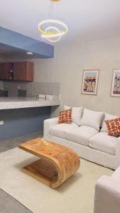 a living room with a couch and a coffee table at Kaizen Homes in Homa Bay