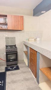 a kitchen with a stove and a counter top at Kaizen Homes in Homa Bay