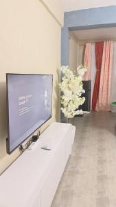 a living room with a flat screen tv on a wall at Kaizen Homes in Homa Bay