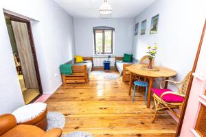 a living room with a table and a couch at Pod lasem in Górowo Iławeckie