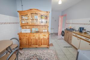 a kitchen with a wooden cabinet and a table at Pod lasem in Górowo Iławeckie +12 photos