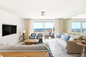 a living room with a couch and a tv at Puerto Banus Harbour View Apartment in Marbella