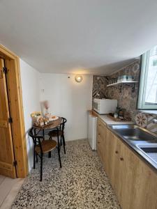 a small kitchen with a table and a sink at Nostalgia Traditional Home in Skiros