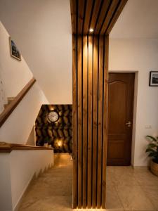 a hallway with a wooden door and a stack of logs at Vila Iepurasul Sinaia in Sinaia