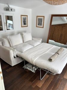 a large bed in a room with a couch at Small architect's house in Pantin