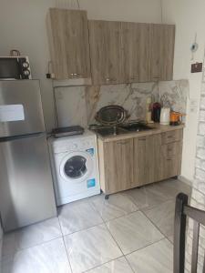a kitchen with a refrigerator and a washing machine at Fatos in Pogradec