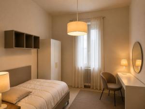 a bedroom with a bed and a desk and a window at Casa Vacanza Saint George - Hotel San Giuseppe Group in Cernobbio