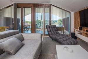 a living room with a couch and two chairs at Zeusplace Olympus Casa in Paralía Skotínis