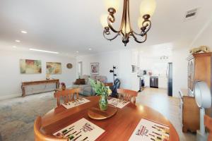 a living room with a dining room table and a kitchen at Portola Oasis - Permit DRO-STR-18 in Monterey