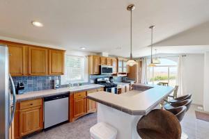 a kitchen with wooden cabinets and a counter top at Nonpariel Escape in Paso Robles