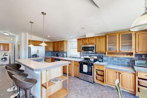 a kitchen with wooden cabinets and a large island at Nonpariel Escape in Paso Robles