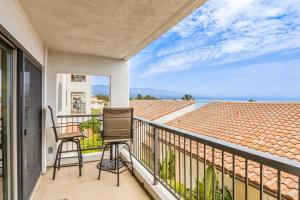 a balcony with two chairs and a view of the ocean at Beach Retreat in Santa Barbara