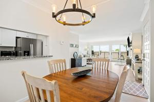 a kitchen and dining room with a wooden table and chairs at Beach Retreat in Santa Barbara +21 photos