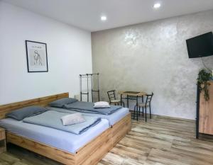 a bedroom with a bed and a table with chairs at Riverstone Retreat Studio in Jajce