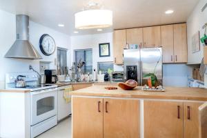 a kitchen with wooden cabinets and a white refrigerator at The Silver Lady in Cambria