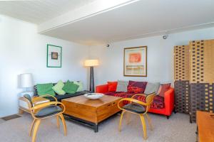 a living room with a red couch and chairs at The Silver Lady in Cambria
