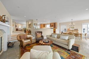a living room with a couch and a fireplace at Sand Side Bliss in Oxnard +25 photos