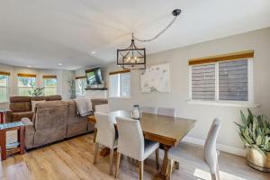 a dining room and living room with a table and a couch at Wanderlust Cambria Seaside Village in Cambria