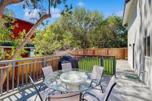 a patio with a glass table and chairs on a balcony at Wanderlust Cambria Seaside Village in Cambria