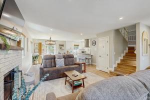 a living room with a couch and a fireplace at Wanderlust Cambria Seaside Village in Cambria