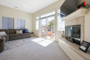 a living room with a couch and a large fireplace at Santo Tomas Getaway in Grover Beach