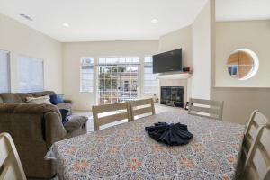 a living room with a table with a black umbrella on it at Santo Tomas Getaway in Grover Beach