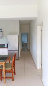 a kitchen with a table and a refrigerator at Sunview in Savusavu