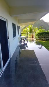 a porch of a house with a bench on it at Sunview in Savusavu